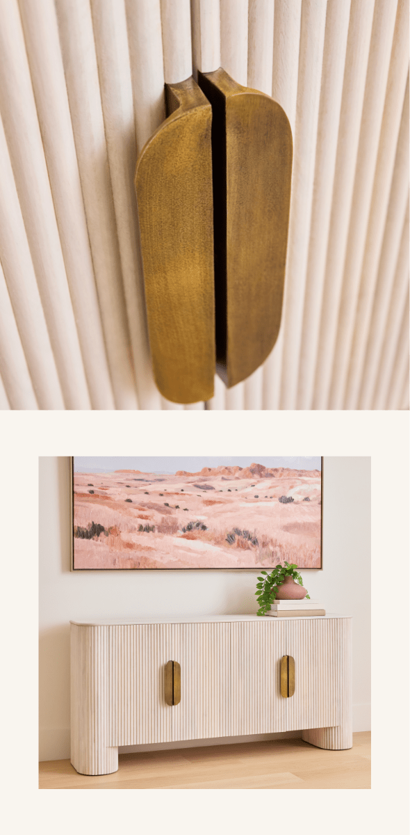 White fluted cabinet with brass handles and desert artwork