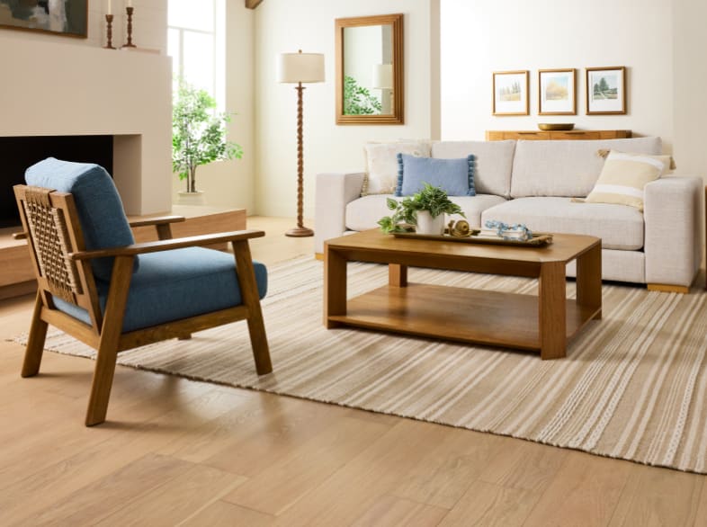 Cotswold Lane living room with neutral seating, blue accents, and wood furniture