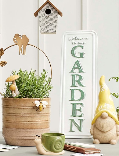 Garden decor with a planter, garden sign, gnome, and birdhouse