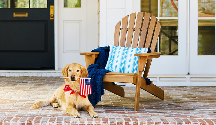 Wood Adirondack chair on a porch with patriotic accents