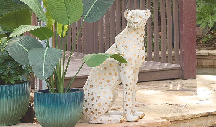 Leopard garden statue beside a potted plant