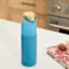 REAL SIMPLE Blue Glass Silicone Sleeve Bottle with Ring Top Carrier, 18oz